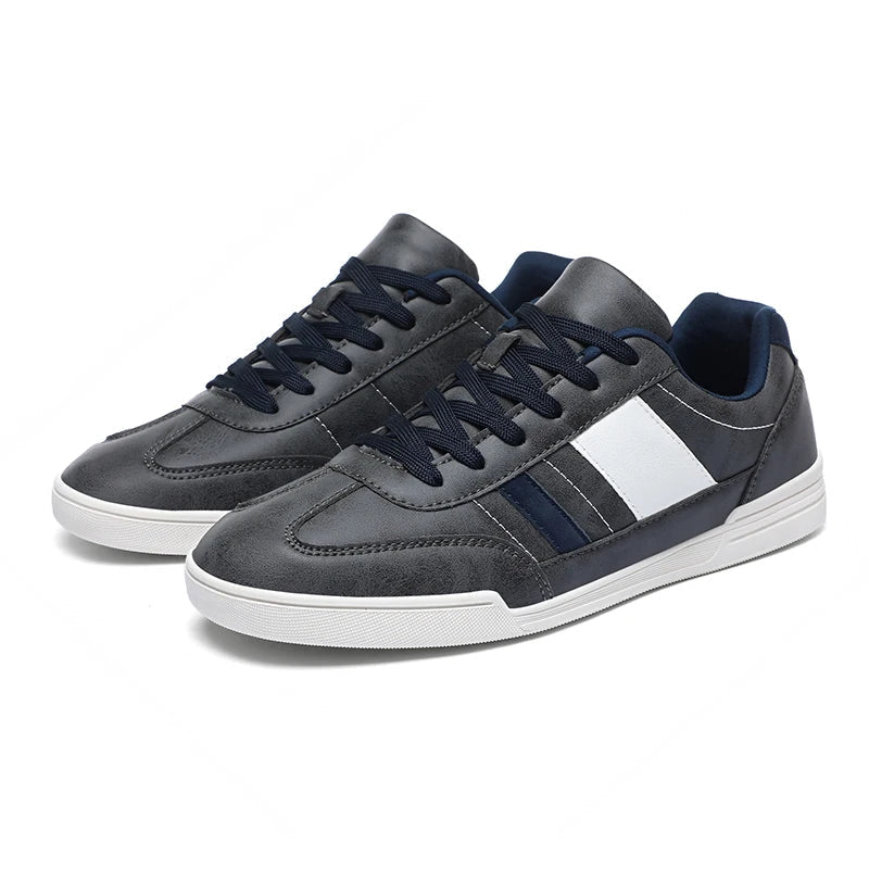 Gray and navy Viero men's low-top sneakers with white stripe accent, navy laces, and white rubber sole.