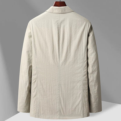 Back view of a men's beige two-button blazer with notch collar, long sleeves, and tailored fit on a wooden hanger.