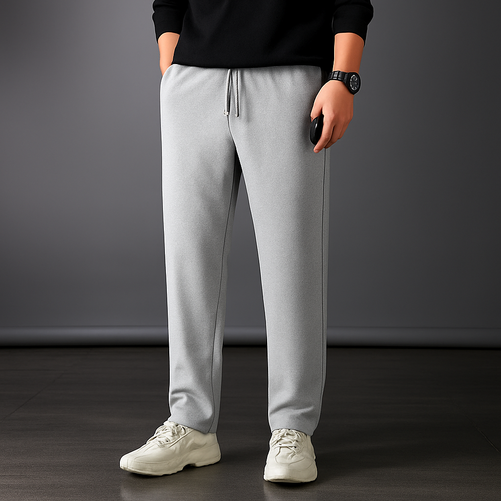 Man wearing light gray ice silk drawstring sweatpants with black top and white sneakers, straight relaxed fit