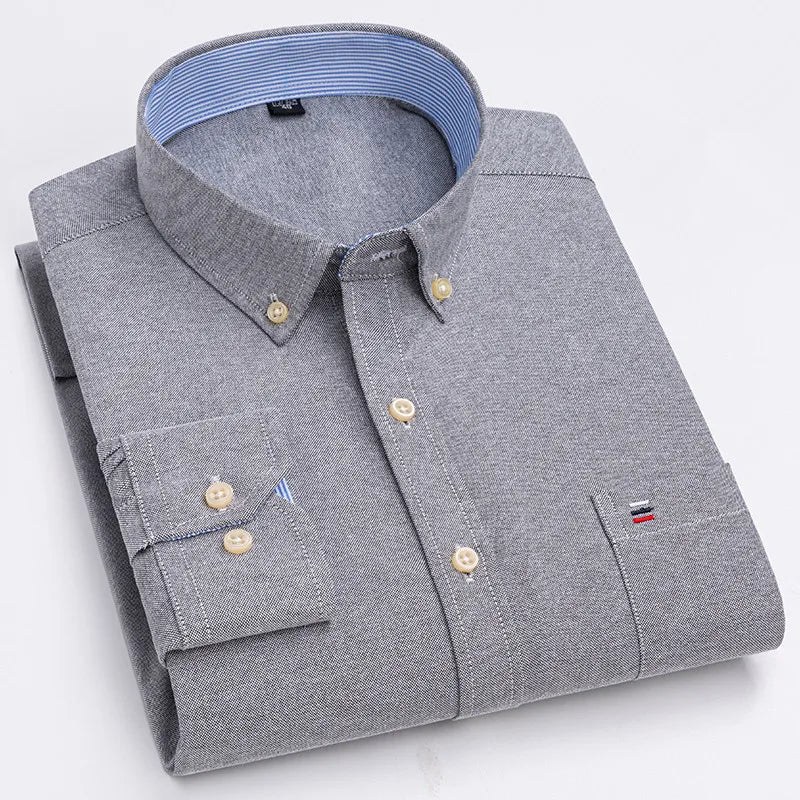 Gray men's cotton button-down shirt with chest pocket, cream buttons, and blue striped collar lining, neatly folded.