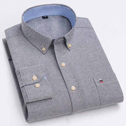Gray men's cotton button-down shirt with chest pocket, cream buttons, and blue striped collar lining, neatly folded.