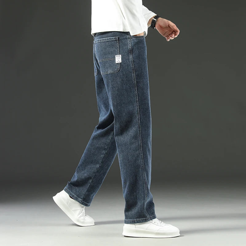 Men's straight leg stretch denim jeans in blue wash with white label pocket detail and relaxed fit