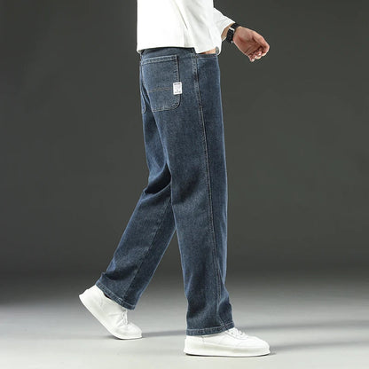 Men's straight leg stretch denim jeans in blue wash with white label pocket detail and relaxed fit