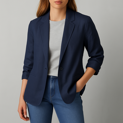 Women's navy blue linen blazer jacket with notch lapels, ruched sleeves, and pockets, styled over a gray tee with jeans.