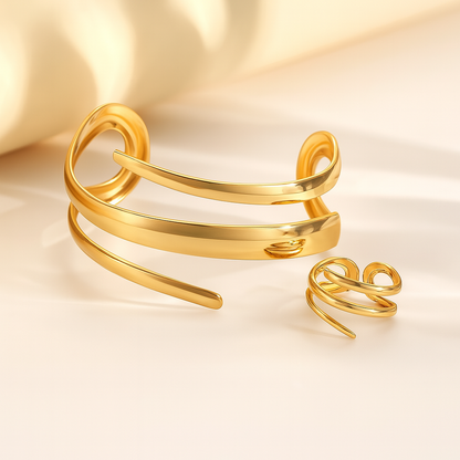 Gold-tone spiral wrap cuff bracelet and matching adjustable ring jewelry set for women on beige background