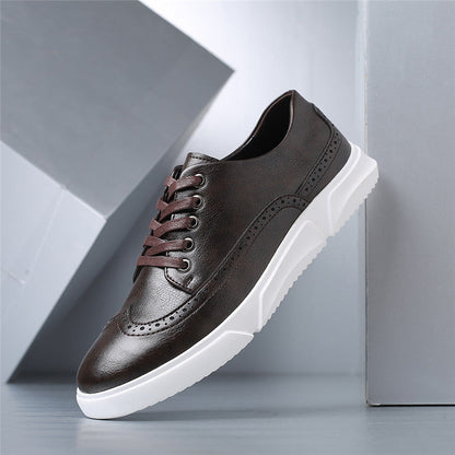 Dark brown men's leather brogue sneakers with white sole and brown laces, angled product view on gray background