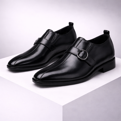 Black leather double monk strap dress shoes for men with metal buckles on white display platform