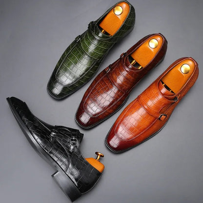 Four men's crocodile-pattern leather double monk strap dress shoes in green, brown, tan, and black colors with shoe trees inserted.
