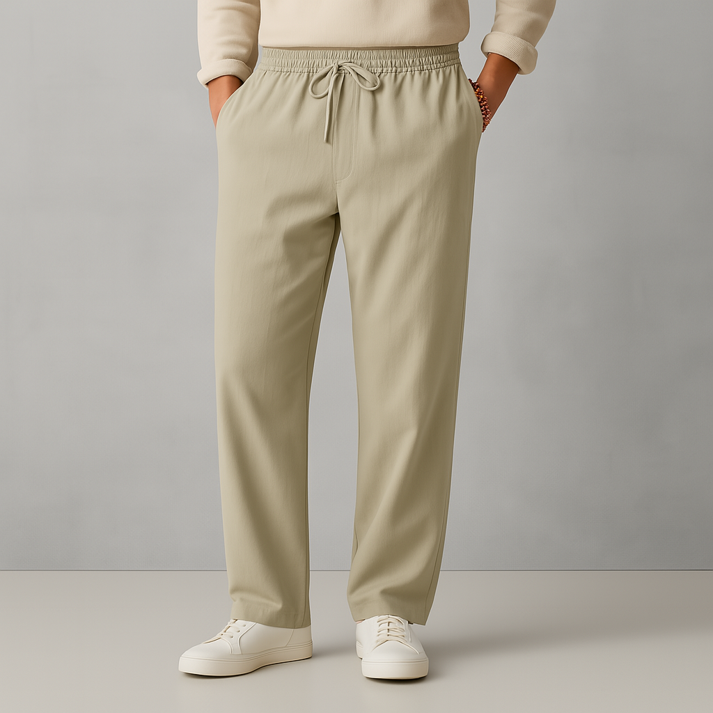 Men's beige linen drawstring casual pants with elastic waistband, straight leg fit, worn with white sneakers.
