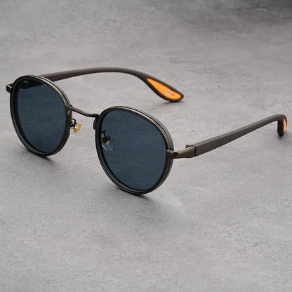 Round frame UV400 sunglasses for men with dark blue lenses and gunmetal gray temples with orange accents