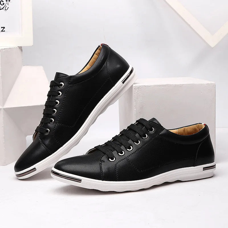 Black leather low-top lace-up sneakers for men with white sole, metallic eyelets, and smooth upper on white display blocks