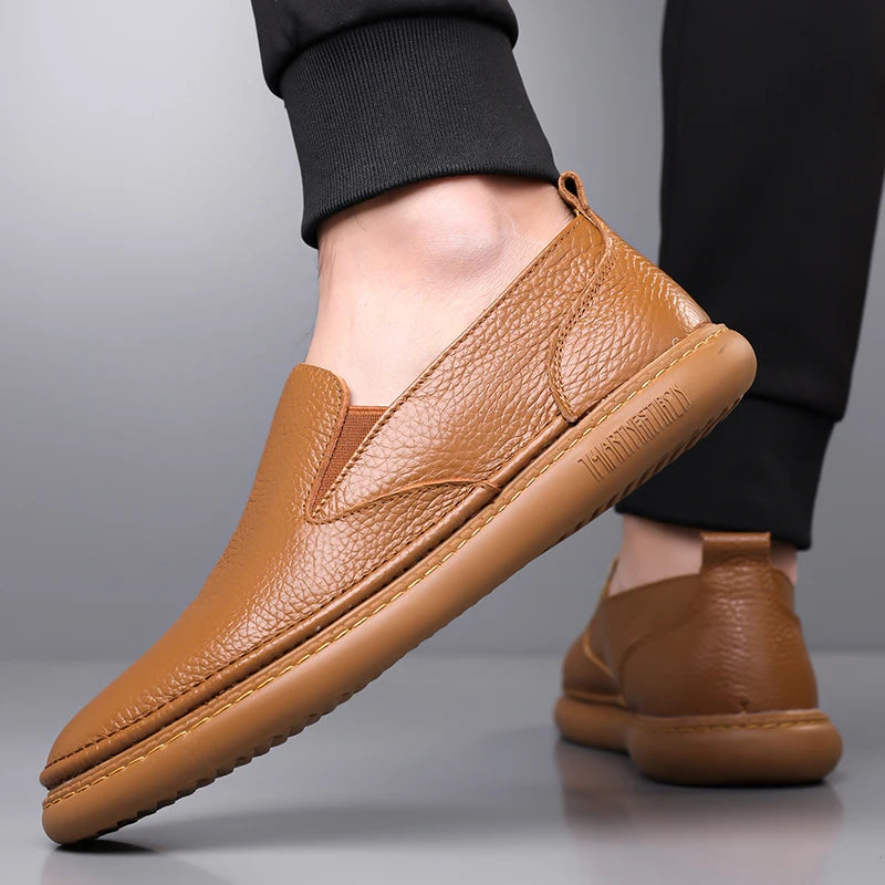 Men's brown leather slip-on loafers with textured grain finish and comfortable flat sole casual shoes