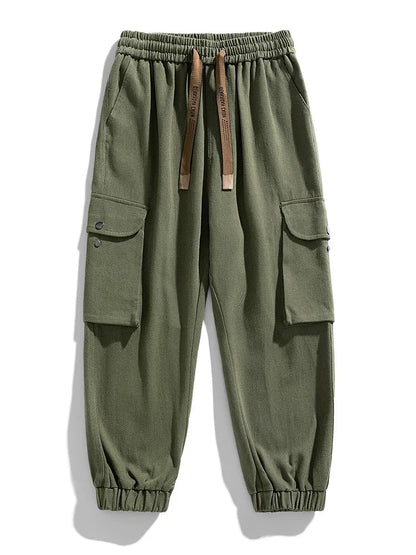 Army green men's cargo joggers with side pockets, elastic waistband, drawstring, and tapered ankles.