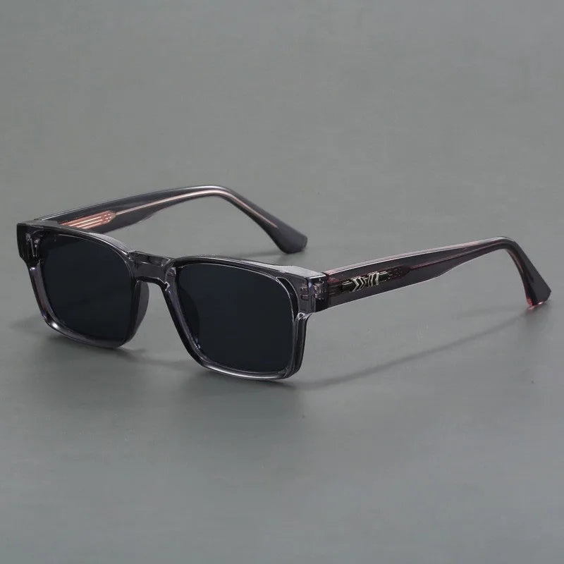 Square frame UV400 sunglasses for men with transparent gray acetate frame, dark lenses, and decorative metal temple detail.