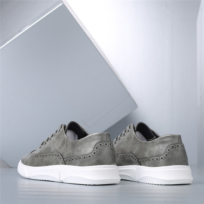 Gray men's Brogan leather lace-up sneakers with brogue detailing and white chunky sole, rear view