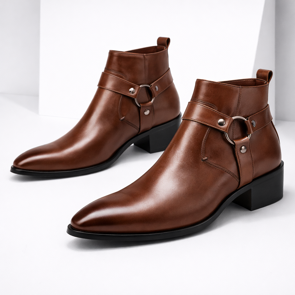 Men's brown leather harness ankle boots with metal ring buckle detail and block heel on white background