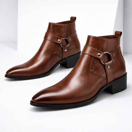 Men's brown leather harness ankle boots with metal ring buckle detail and block heel on white background