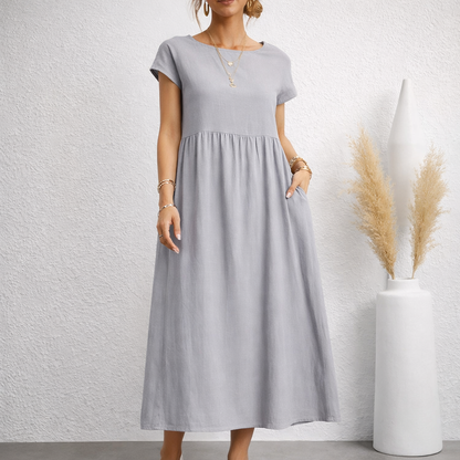 Women's light gray linen relaxed midi dress with short sleeves, empire waist, flowing skirt, and side pockets
