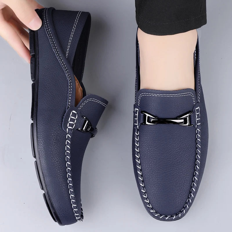 Navy blue leather men's loafers with white contrast stitching and silver metal buckle detail slip-on driving shoes