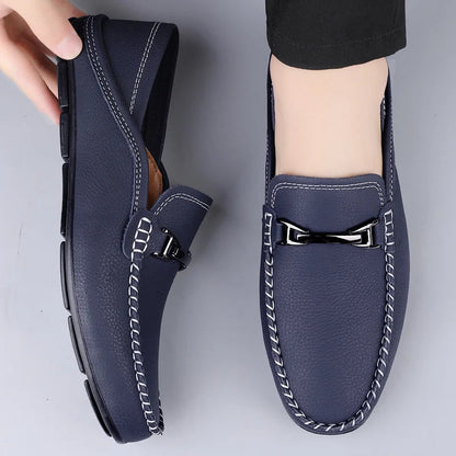 Navy blue leather men's loafers with white contrast stitching and silver metal buckle detail slip-on driving shoes