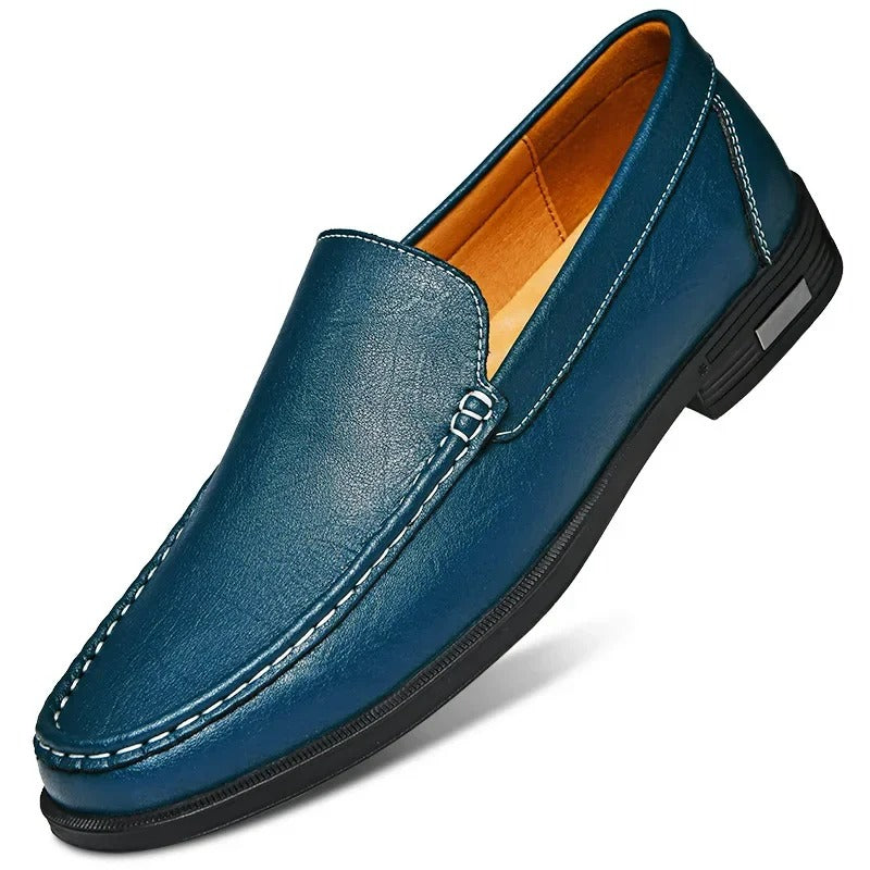 Blue leather men's slip-on loafer with white contrast stitching, orange interior lining, and black rubber sole.
