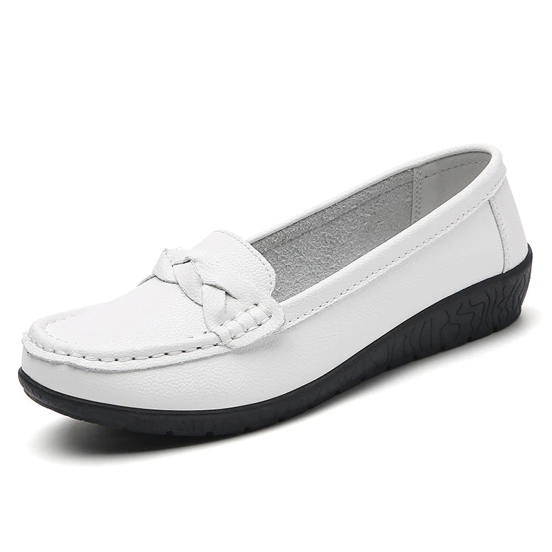 White women's leather slip-on loafers with braided strap detail and black rubber sole, flat casual style
