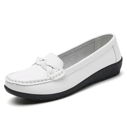 White women's leather slip-on loafers with braided strap detail and black rubber sole, flat casual style