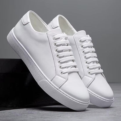 White leather lace-up sneakers for men with flat sole, displayed in pairs against gray background