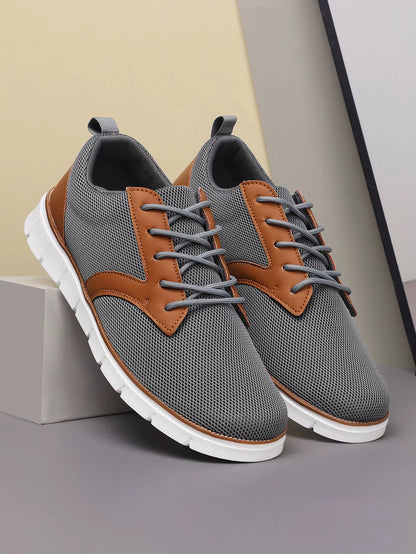 Gray and tan canvas leather orthopedic sneakers with lace-up closure and white cushioned sole, side view.