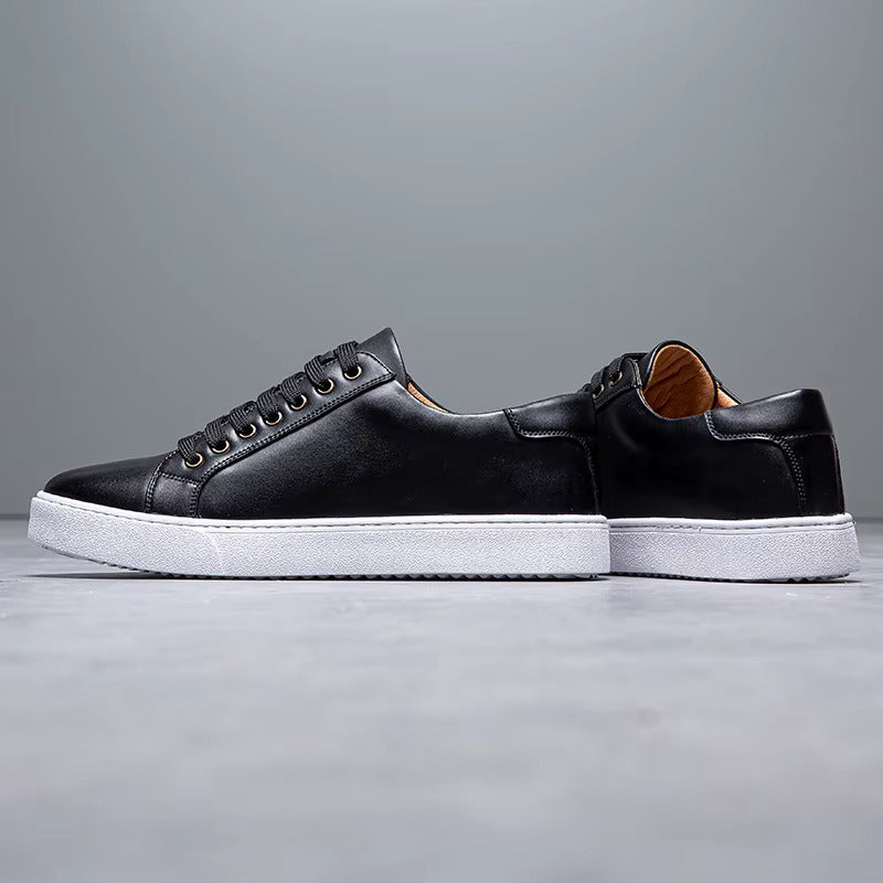Black leather lace-up men's sneakers with white rubber sole and tan interior heel lining, side profile view