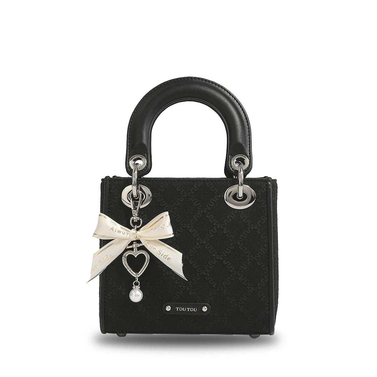 Black jacquard mini handbag with top handle, cream ribbon bow charm, heart pendant, and pearl drop accent by Toutou