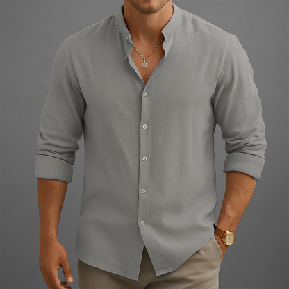 Men's gray linen band collar button-up shirt with rolled sleeves, worn with khaki pants and gold watch.