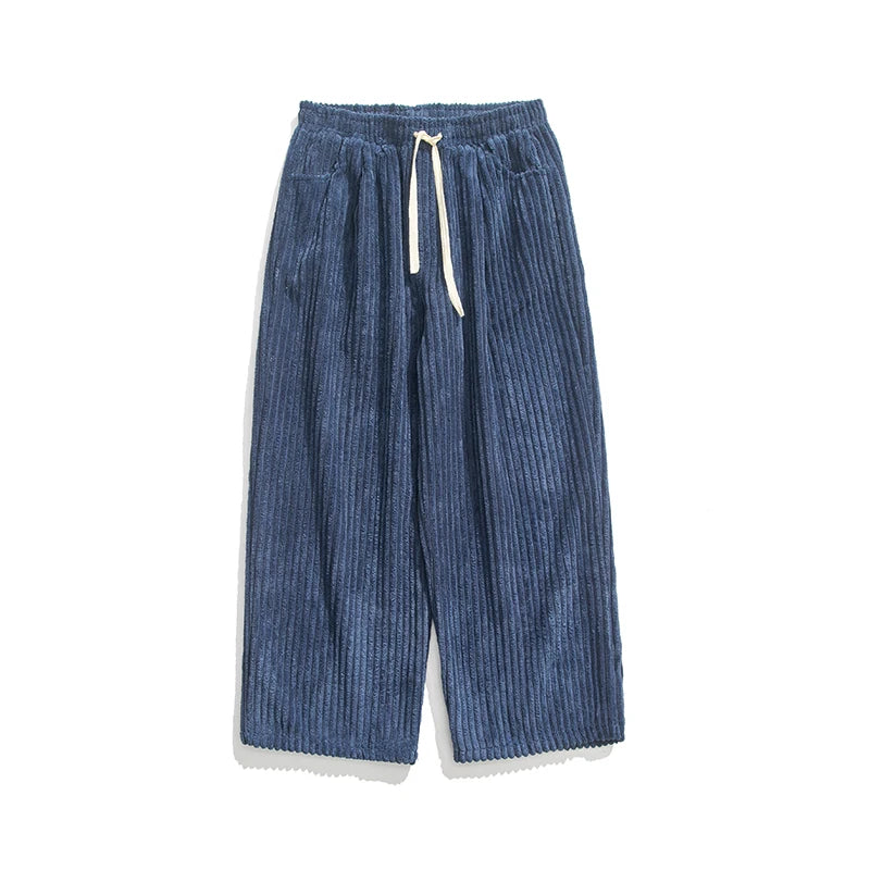 Blue wide-leg corduroy drawstring pants with elastic waist, vertical ribbed texture, and cream-colored drawstring tie.