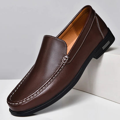 Men's brown leather slip-on loafers with white contrast stitching and black rubber sole