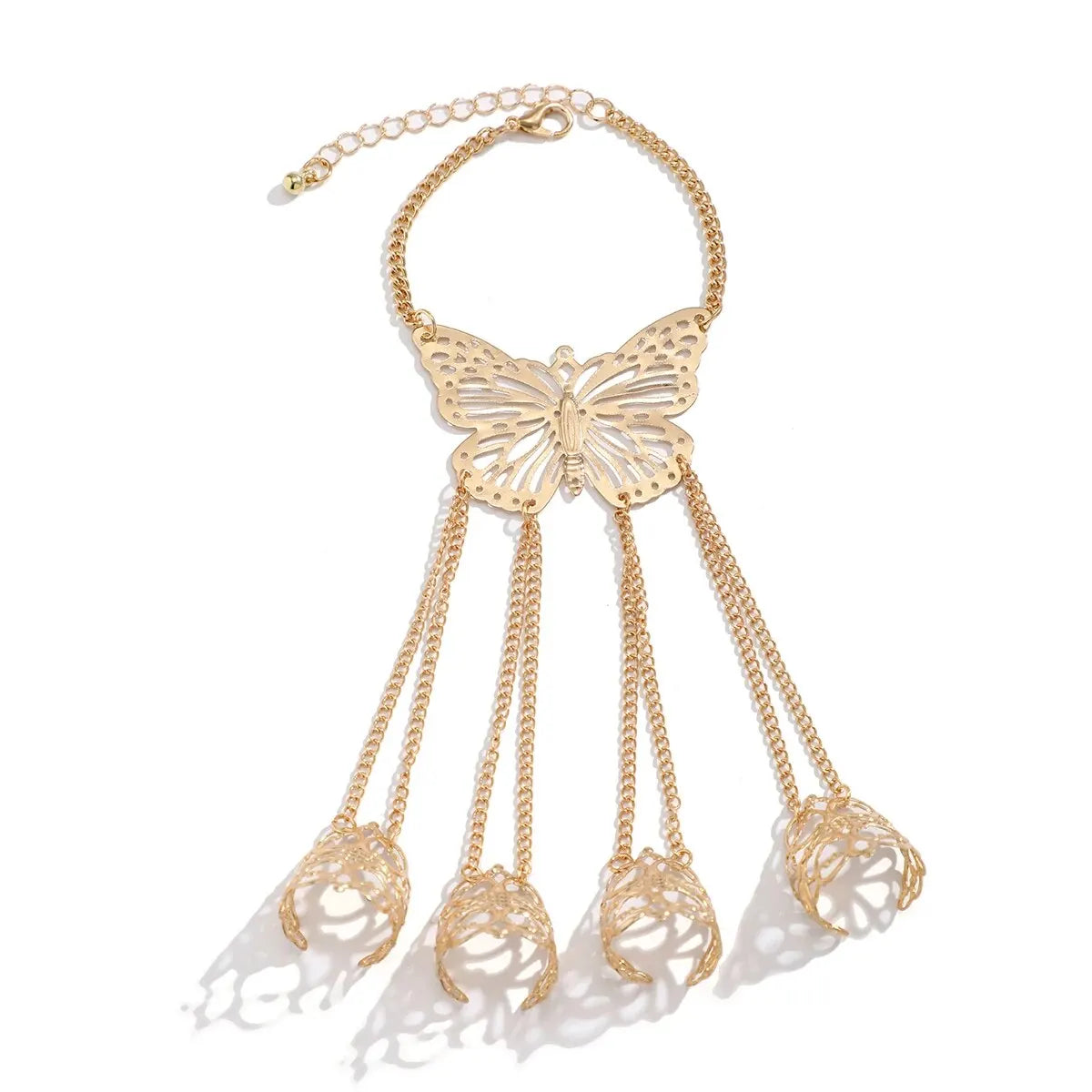 Gold butterfly hand chain bracelet with finger rings, hollow filigree butterfly pendant and tassel chains connecting four finger cuffs