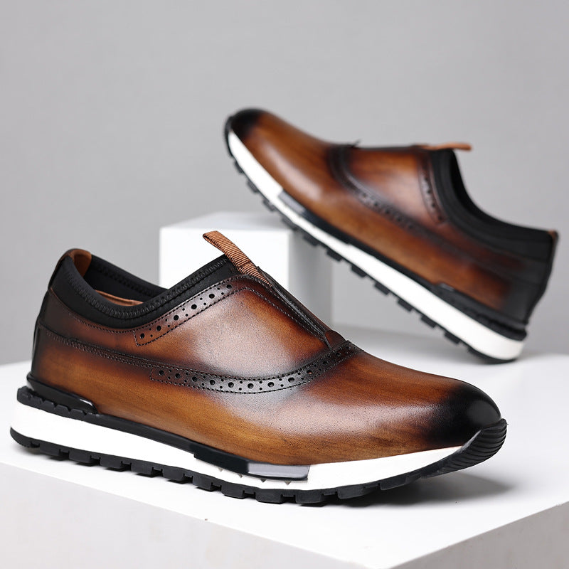 Men's brown leather slip-on loafers with brogue detail and white athletic sole for casual comfort wear