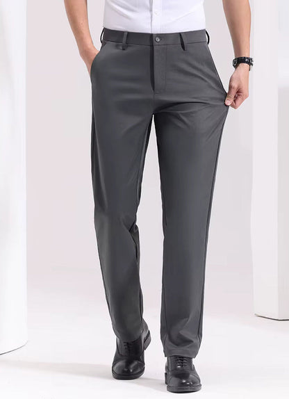 Man wearing Viero slim-fit gray cotton dress trousers with black leather shoes and white shirt, front view.