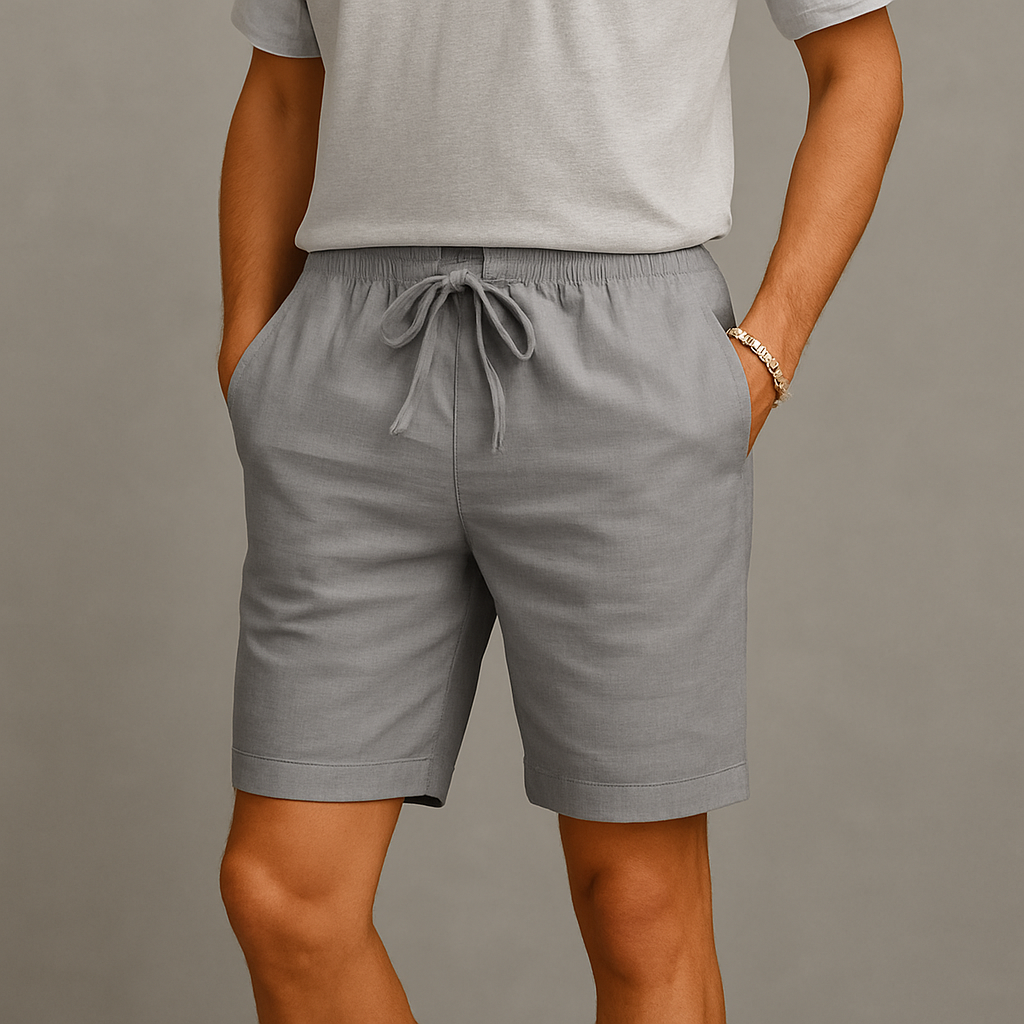 Men's gray linen drawstring shorts with elastic waistband and side pockets, paired with a matching gray t-shirt.
