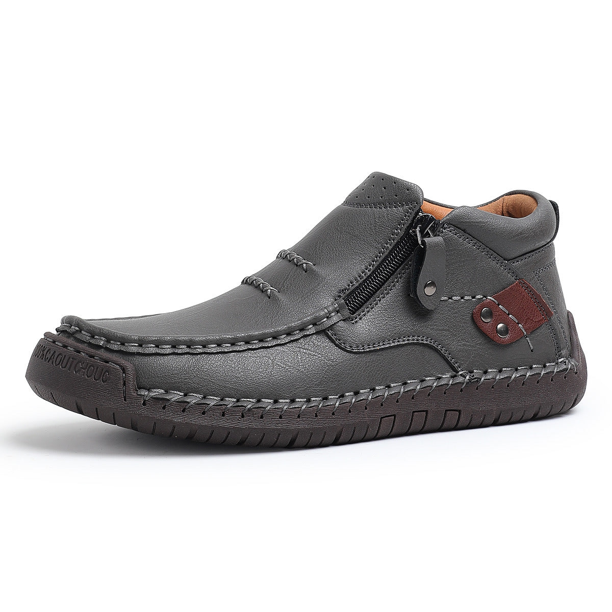 Gray men's leather slip-on ankle boots with side zipper, hand stitching, brown accent patch, and rubber sole.