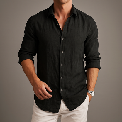 Man wearing a black linen button-up shirt with white pants and a silver watch, showcasing a relaxed yet polished fit.