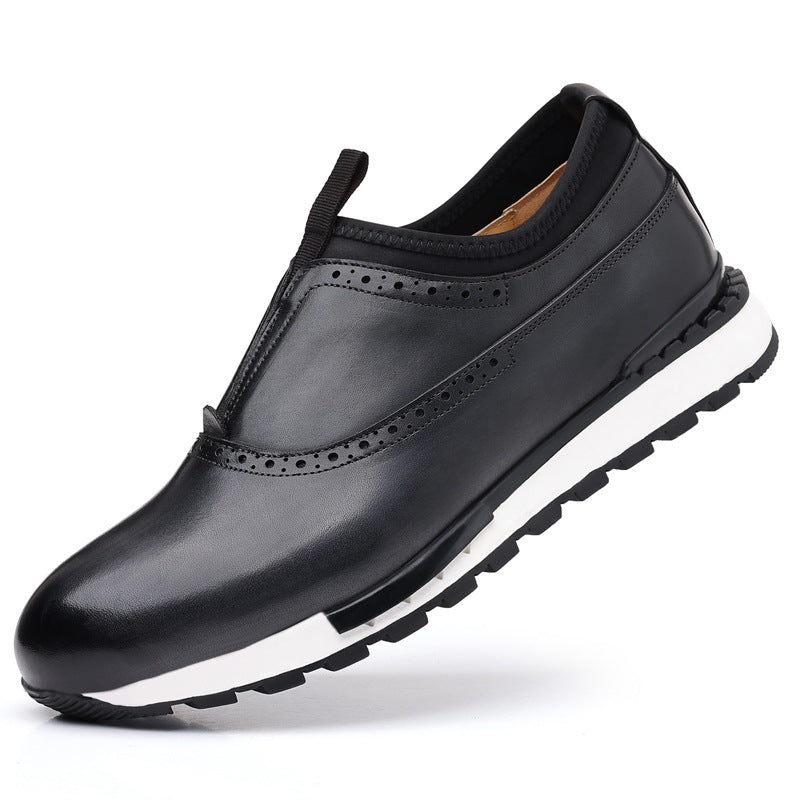 Black men's leather slip-on loafers with brogue perforations, white rubber sole, and pull tab on white background