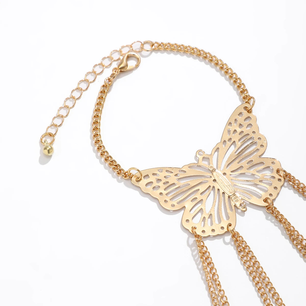 Gold hollow butterfly hand chain bracelet with tassel chains, lobster clasp closure, and adjustable extender link