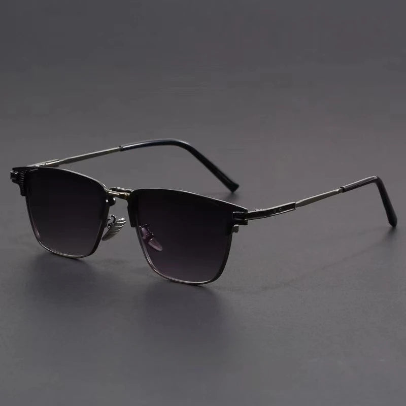 Metal frame polarized sunglasses for men with dark gradient lenses and silver temples on gray background