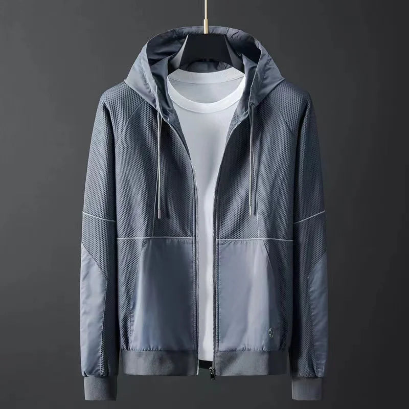 Men's gray hooded zip-up jacket with mesh panels and color block design on mannequin
