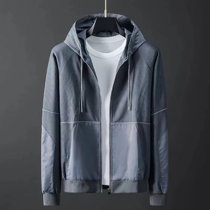 Men's gray hooded zip-up jacket with mesh panels and color block design on mannequin