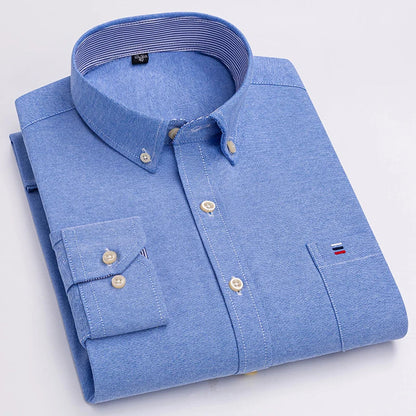 Men's light blue cotton button-down shirt with long sleeves, chest pocket, and embroidered logo detail, folded view