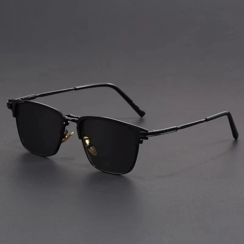 Black metal frame polarized sunglasses for men with dark lenses and sleek design on gray background