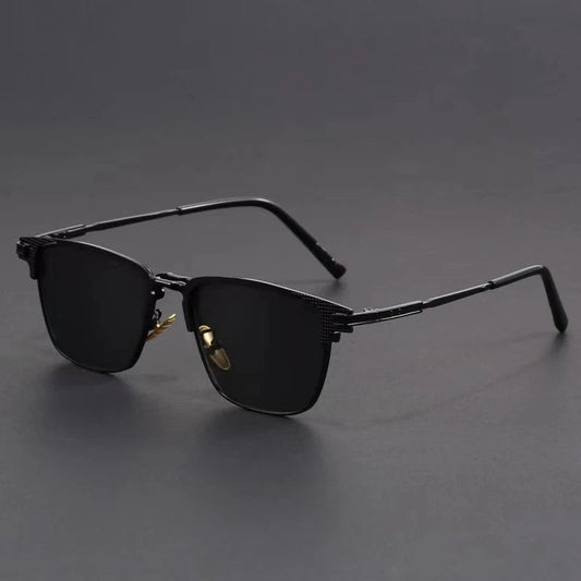 Black metal frame polarized sunglasses for men with dark lenses and sleek design on gray background
