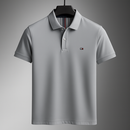 Gray men's cotton polo shirt with collar, short sleeves, button placket, and small logo on chest, displayed on hanger.
