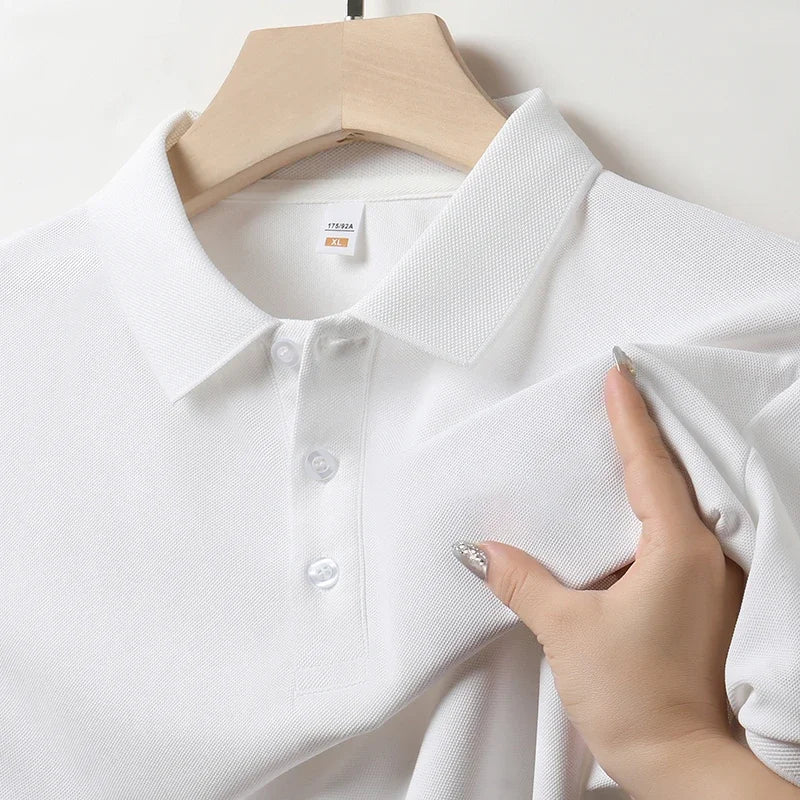 White men's cotton polo shirt on hanger, XL size, pique fabric texture, three-button placket, shown with hand demonstrating fabric quality.